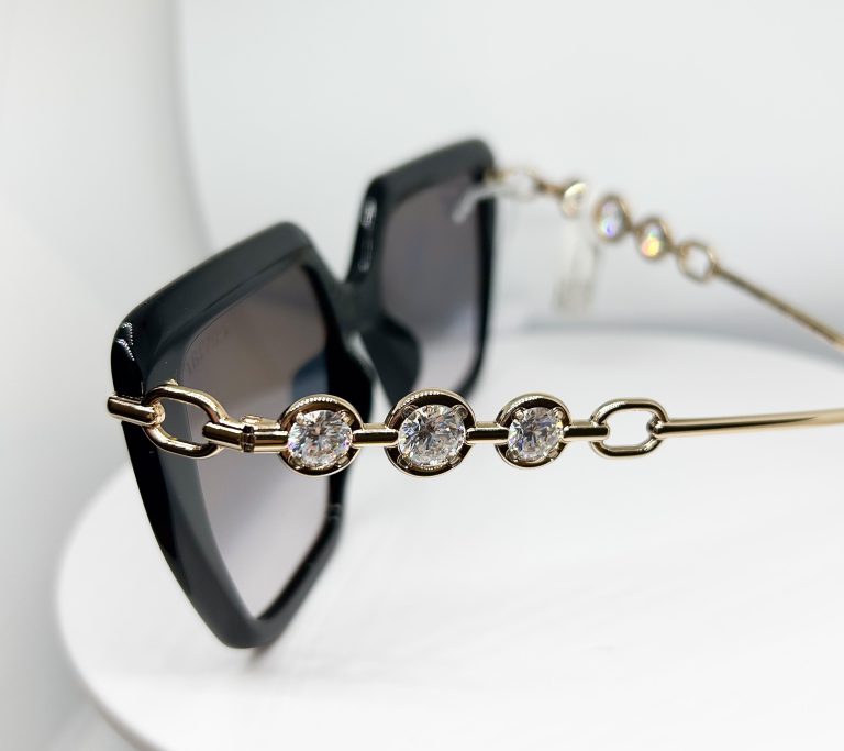 Side of Caviar 6896 that has gold, black; acetate metal sunglasses frame with an Avant Garde shape
