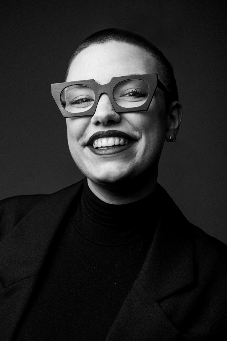 Black and white portrait of a joyful woman wearing Jacques Durand glasses