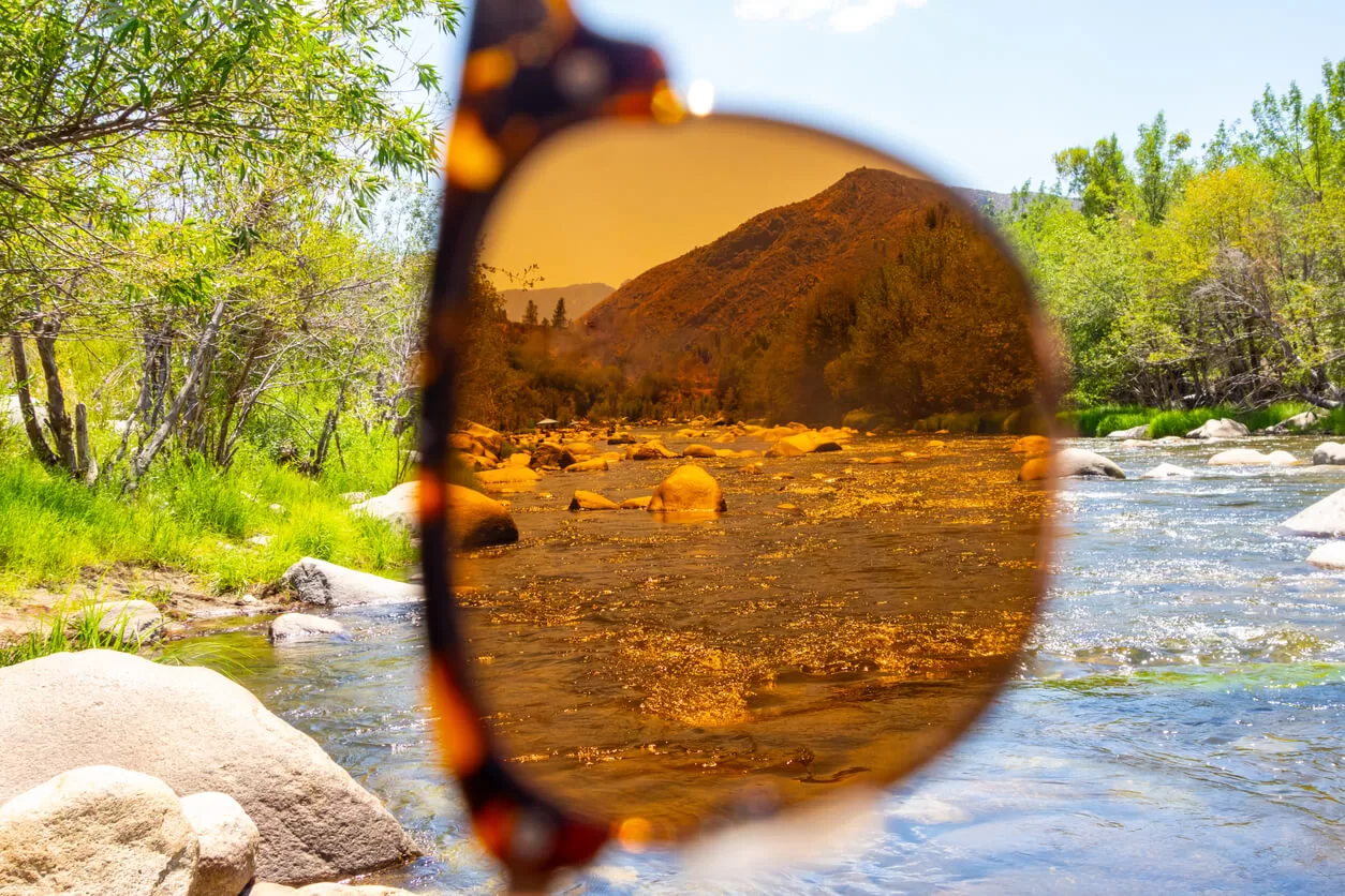 Looking through sunglasses at a river on a weekend getaway