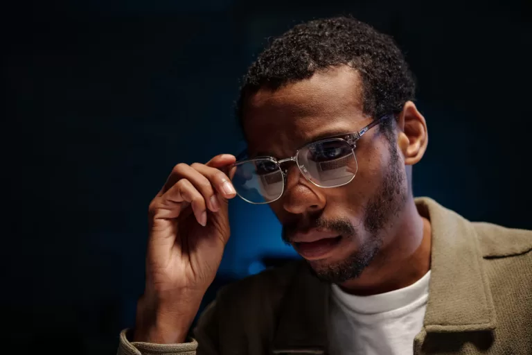 Man wearing luxury eyeglasses indoors with blue light lenses